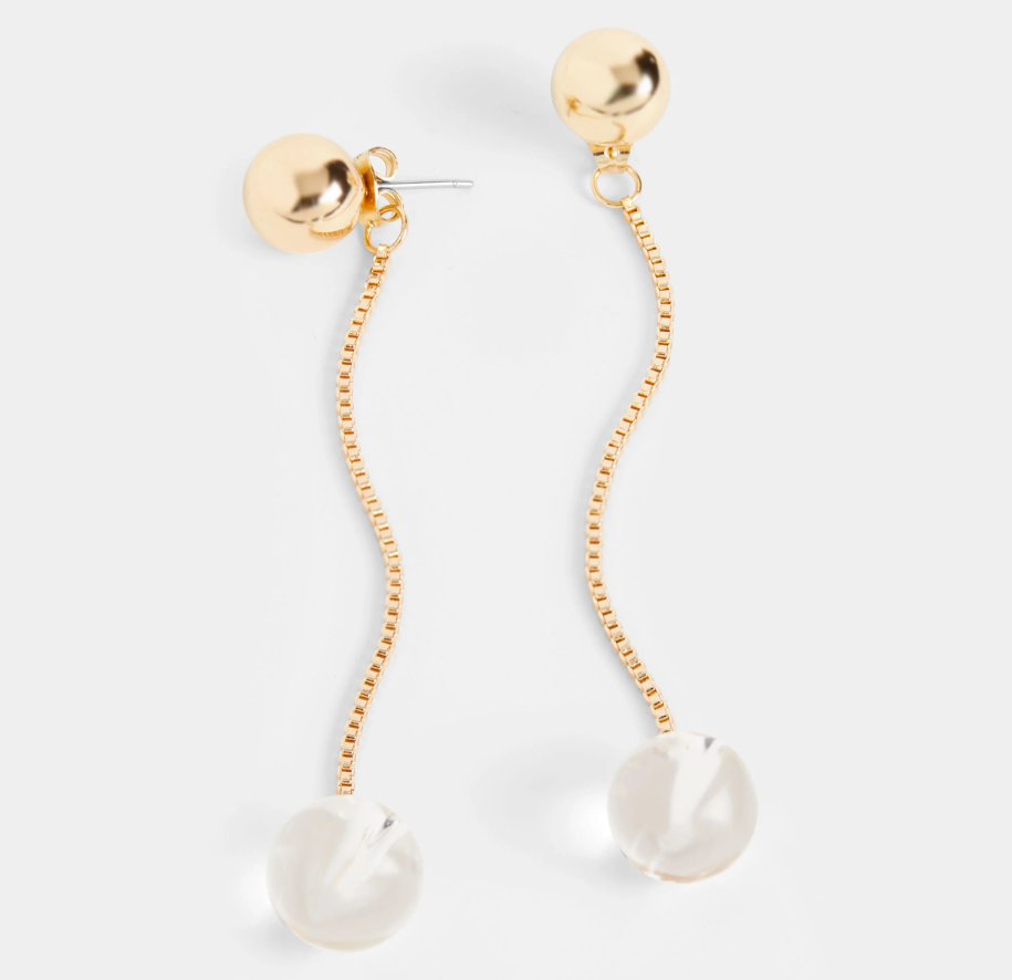 A pair of gold-colored hoop earrings with dangling beads, displayed against a white background.