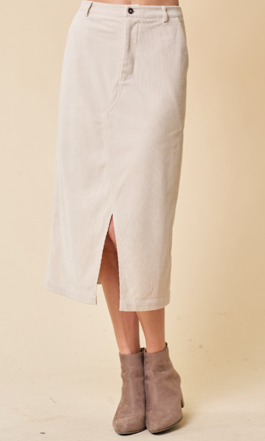 A beige corduroy midi skirt with front slit and pockets, featuring a front zip-up closure.