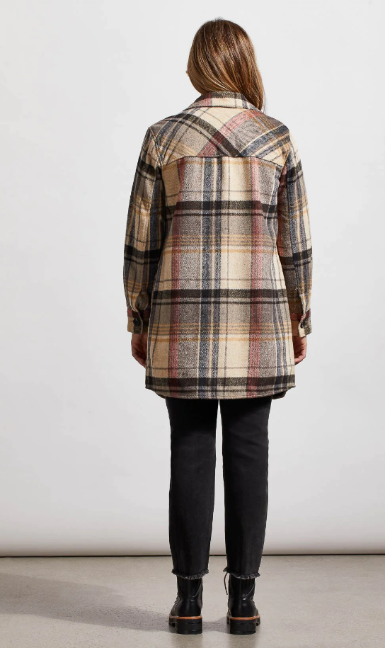 A woman wearing a longline plaid shacket with a notch collar. The shacket is checkered in beige, black, and brown colors.