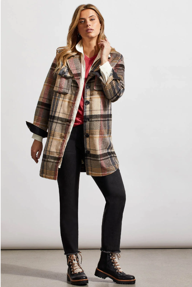 A woman wearing a longline plaid shacket with a notch collar. The shacket is checkered in beige, black, and brown colors.