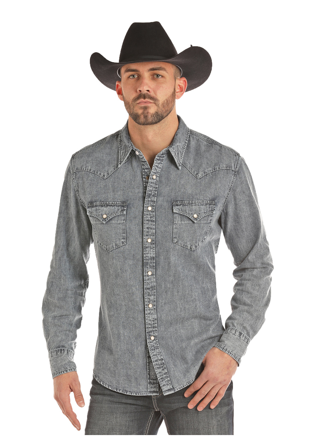 A man wearing a black hat and a gray washed denim slim fit snap shirt with a spread collar and two snap flap pockets.