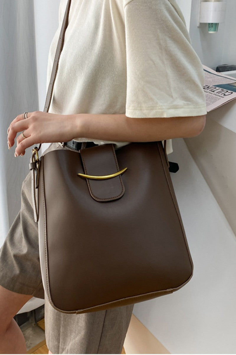 stylish and endlessly practical, this versatile vegan brown leather crossbody
